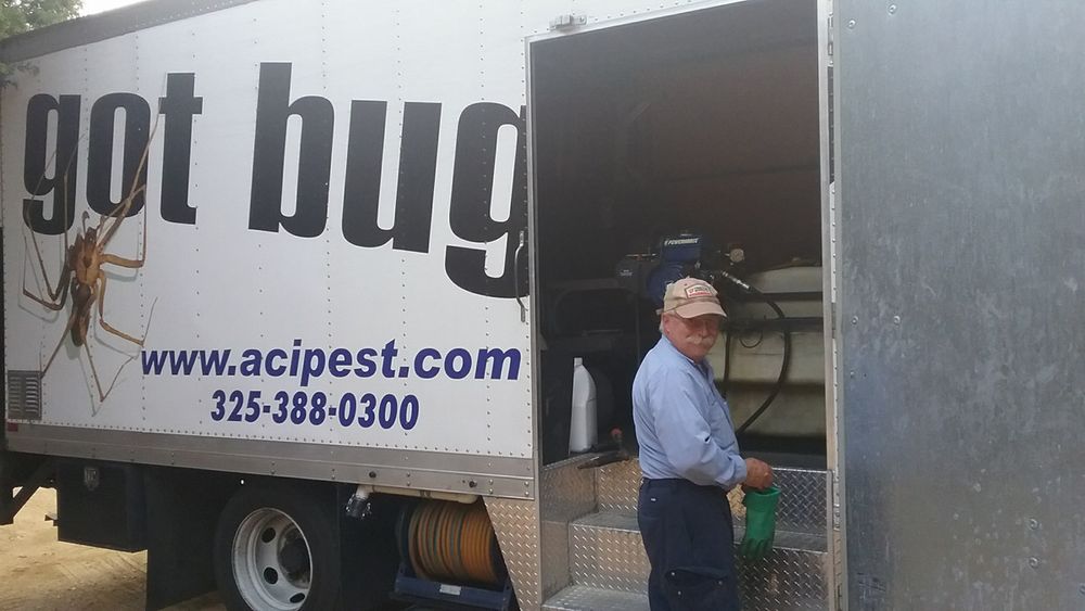 Technician standing beside an ACI box truck