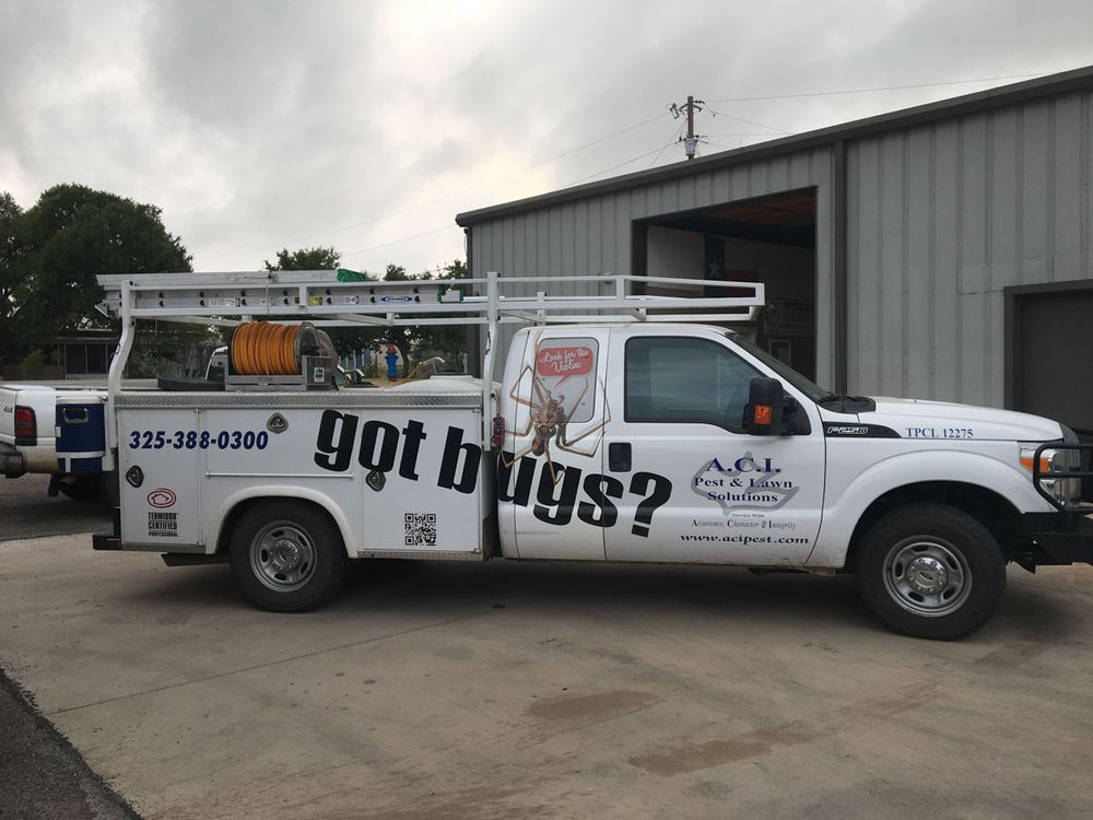 ACI pickup truck parked outside the office