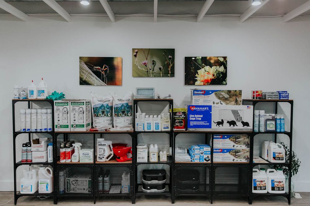 Shelves of professional pest-control supplies in the ACI shop
